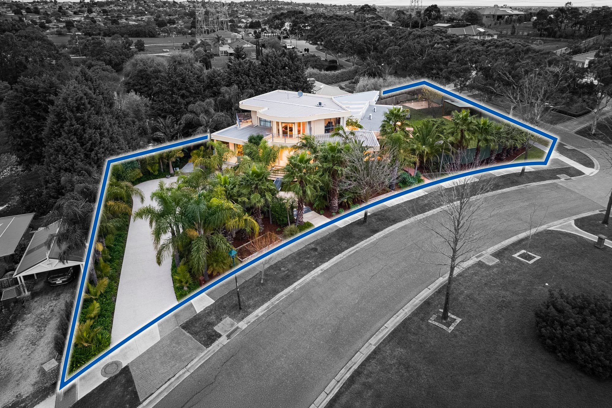 Aerial from the front at dusk, the block outlined in blue with the surrounding streets dropped back to grey