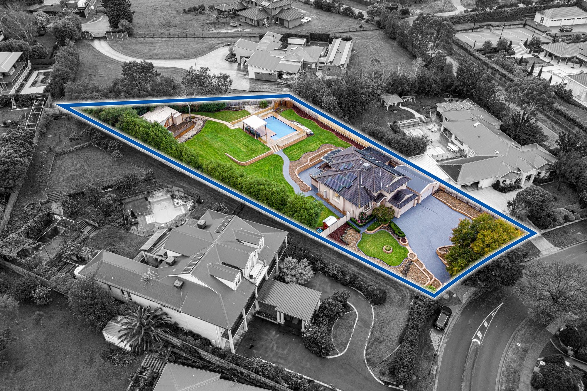 Aerial from the left, the block outlined in blue with the neighbouring properties dropped back to grey