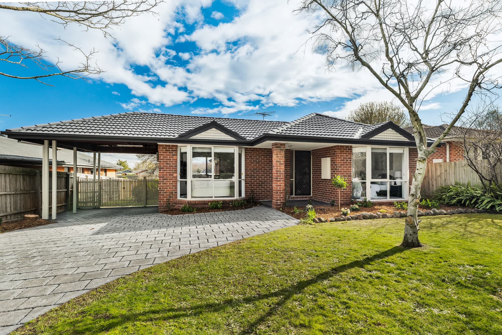 Brick family home with a carport and front lawn, Berwick