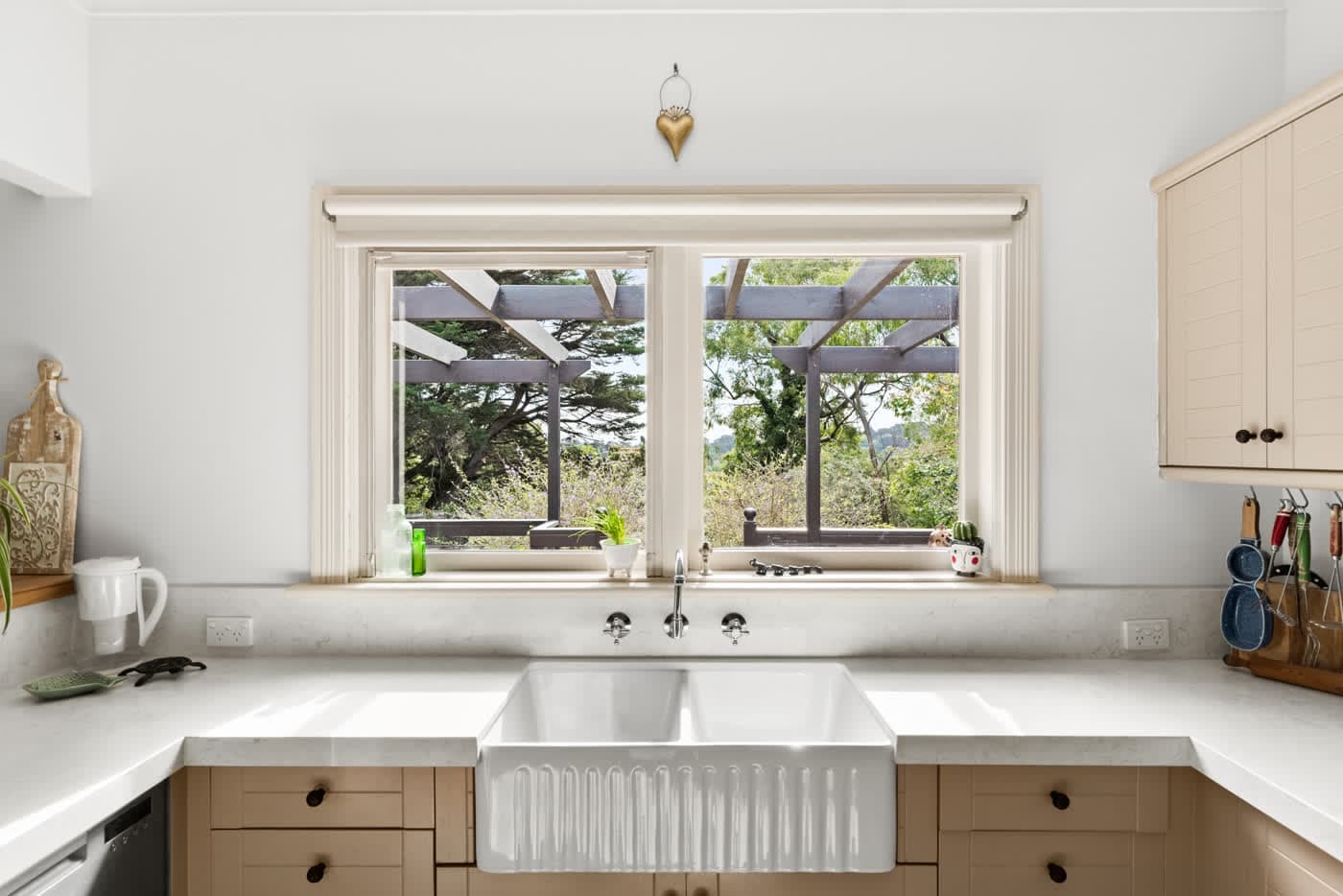 Butler sink beneath a window looking onto the garden