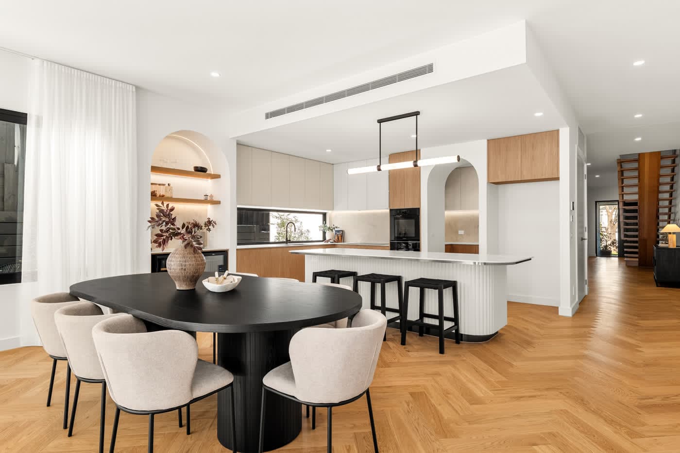 Open-plan dining and kitchen with an arched nook