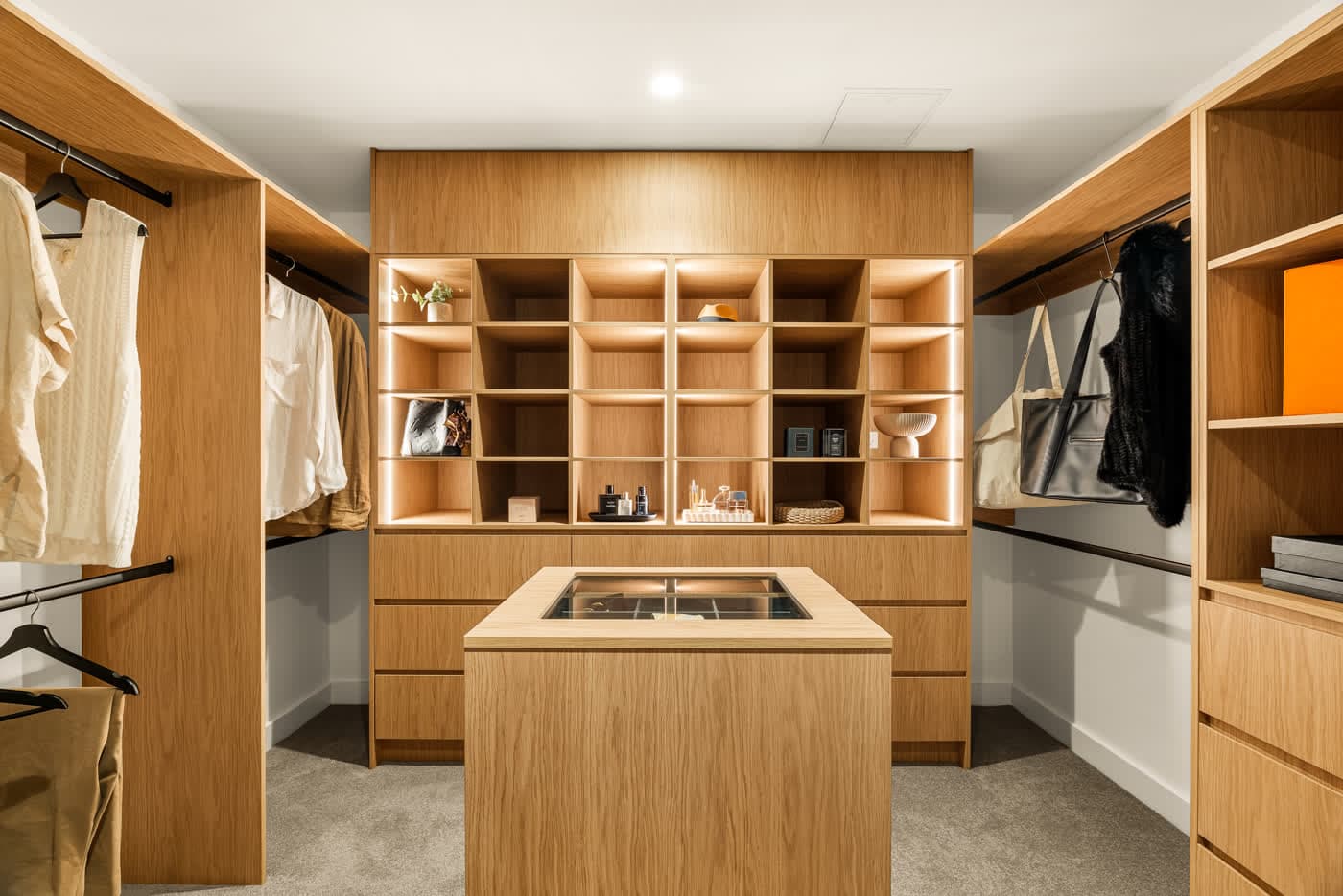 Walk-in dressing room in warm timber joinery