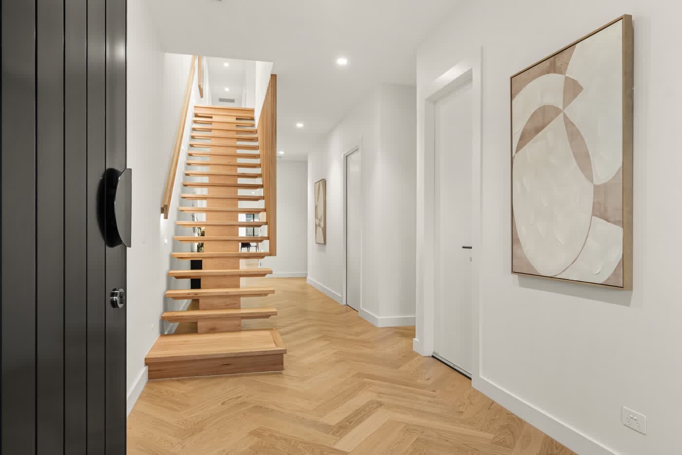 Floating timber staircase above a herringbone floor