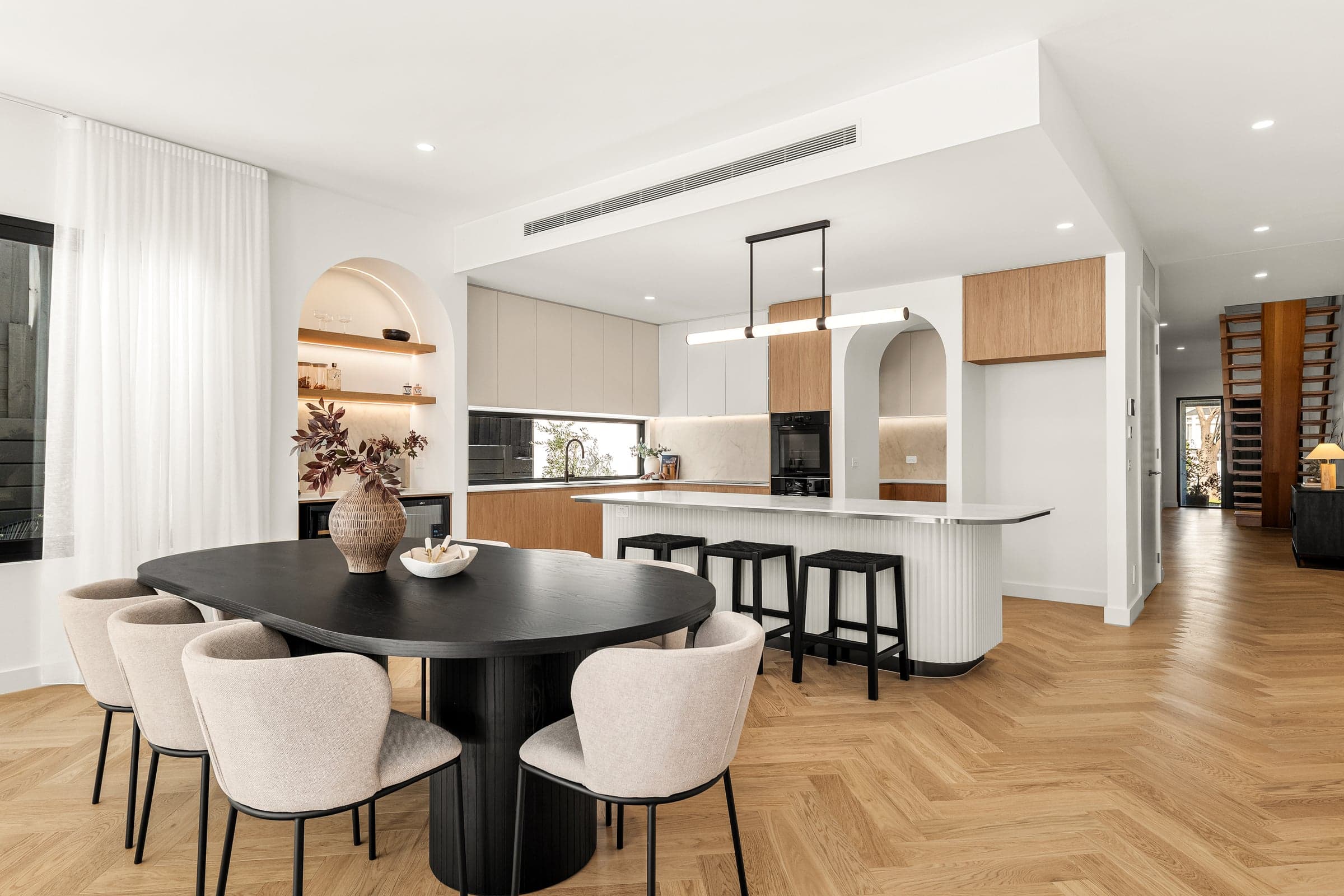 Open-plan dining and kitchen with an arched nook