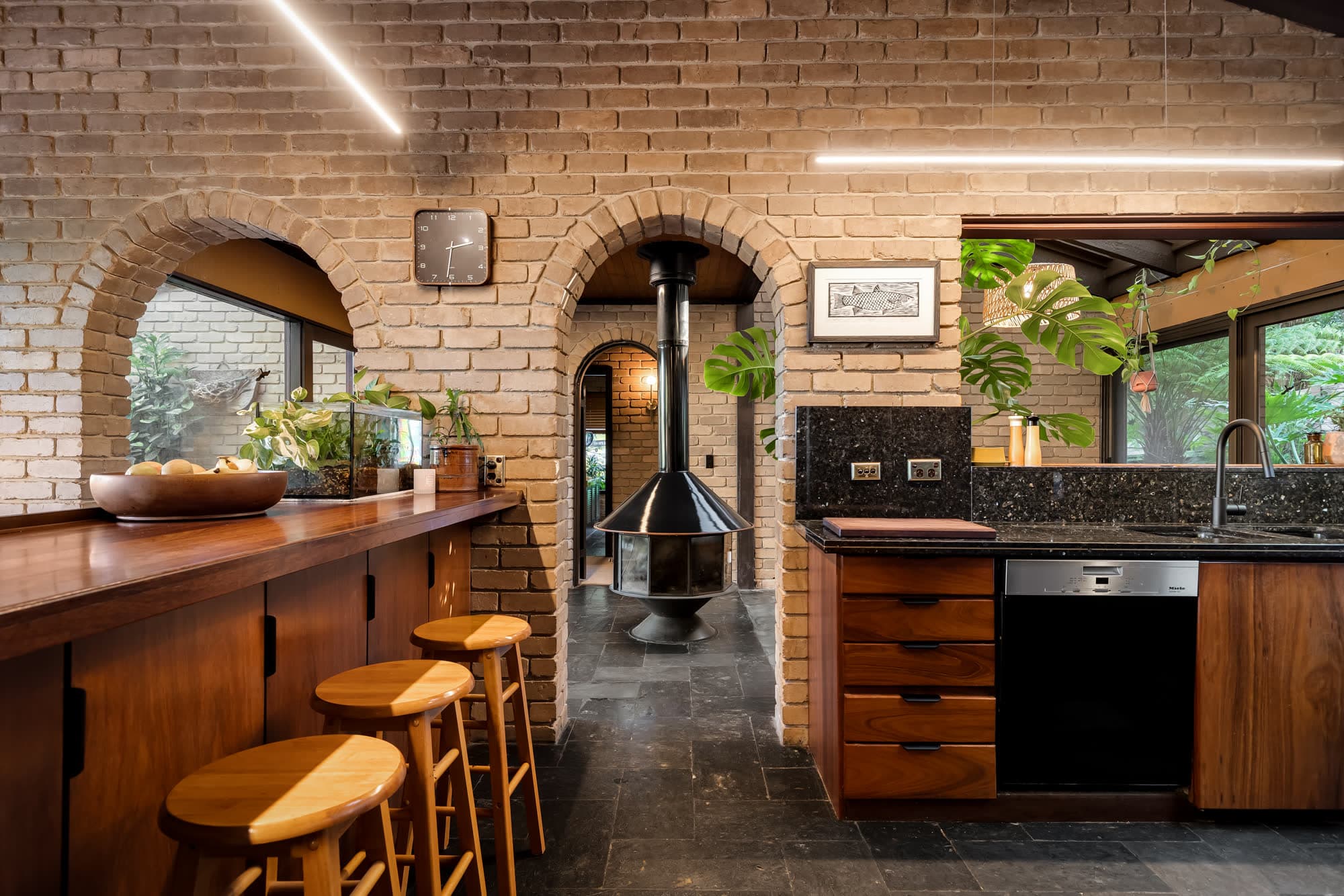 Brick arches and a suspended fireplace under a raked timber ceiling