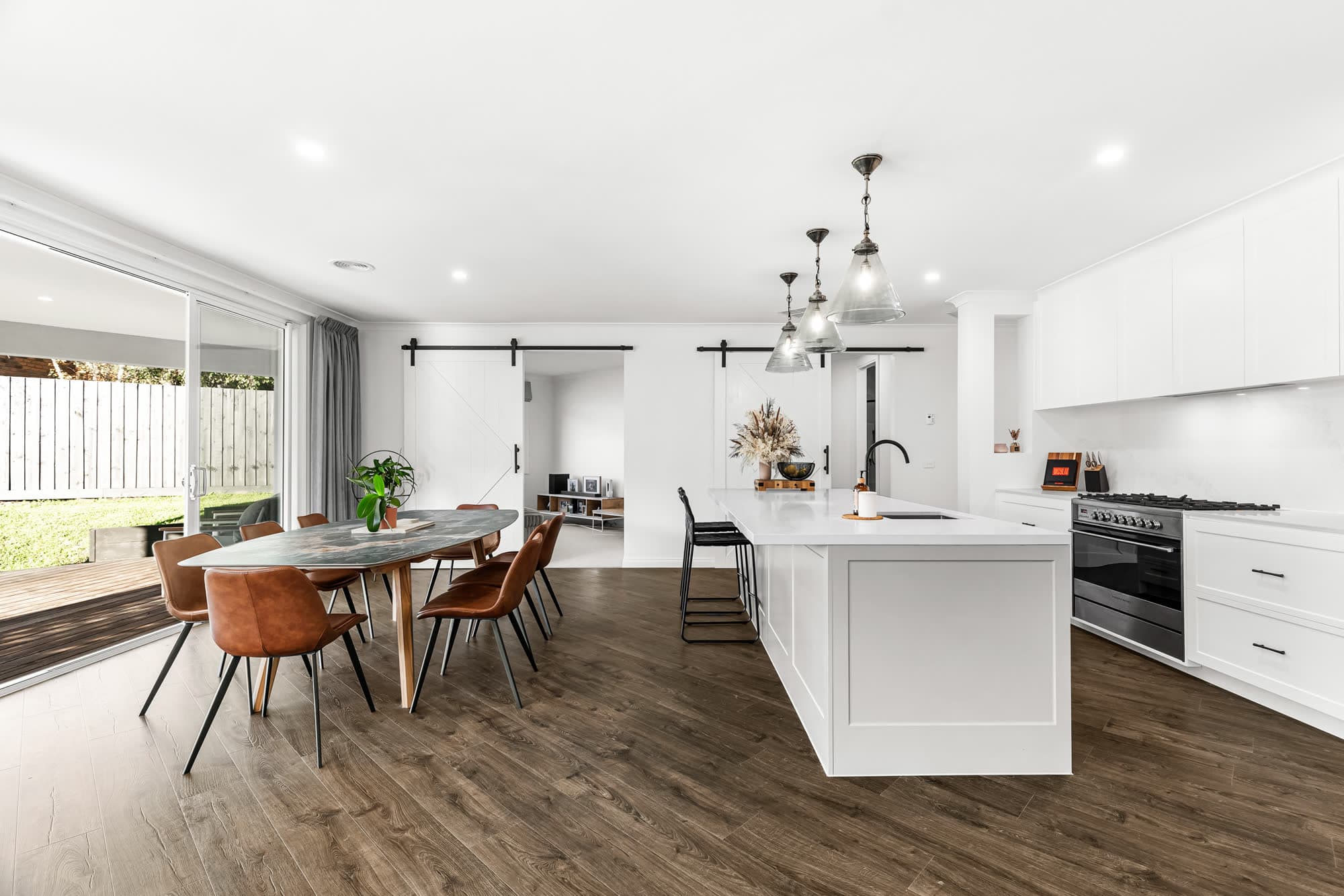 Kitchen and dining with an island bench and pendant lighting