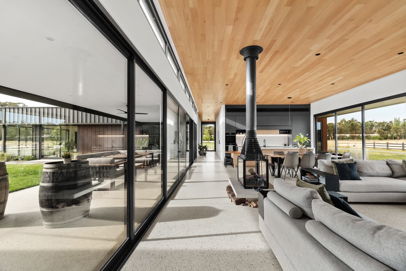 Open living area with a suspended fireplace and paddock views